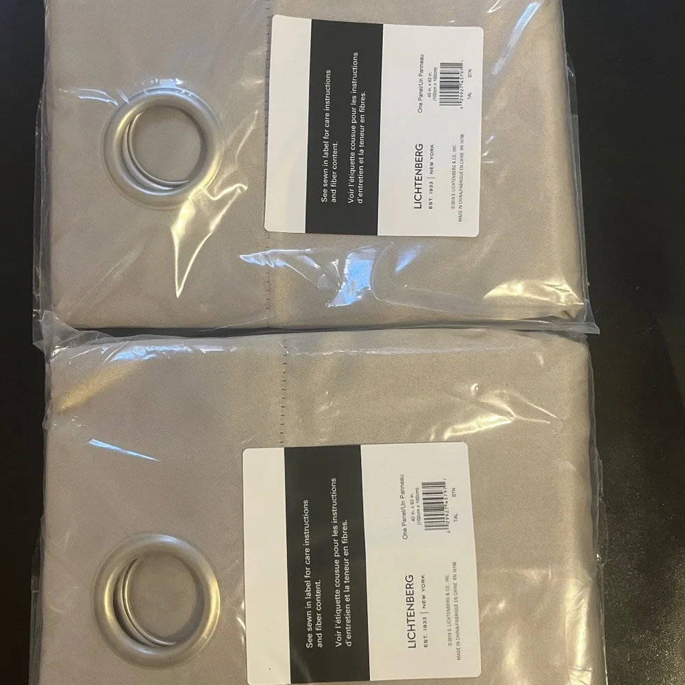 New in package 2 panels of window drapes 40x63”  2 tones gray 6 silver grommets